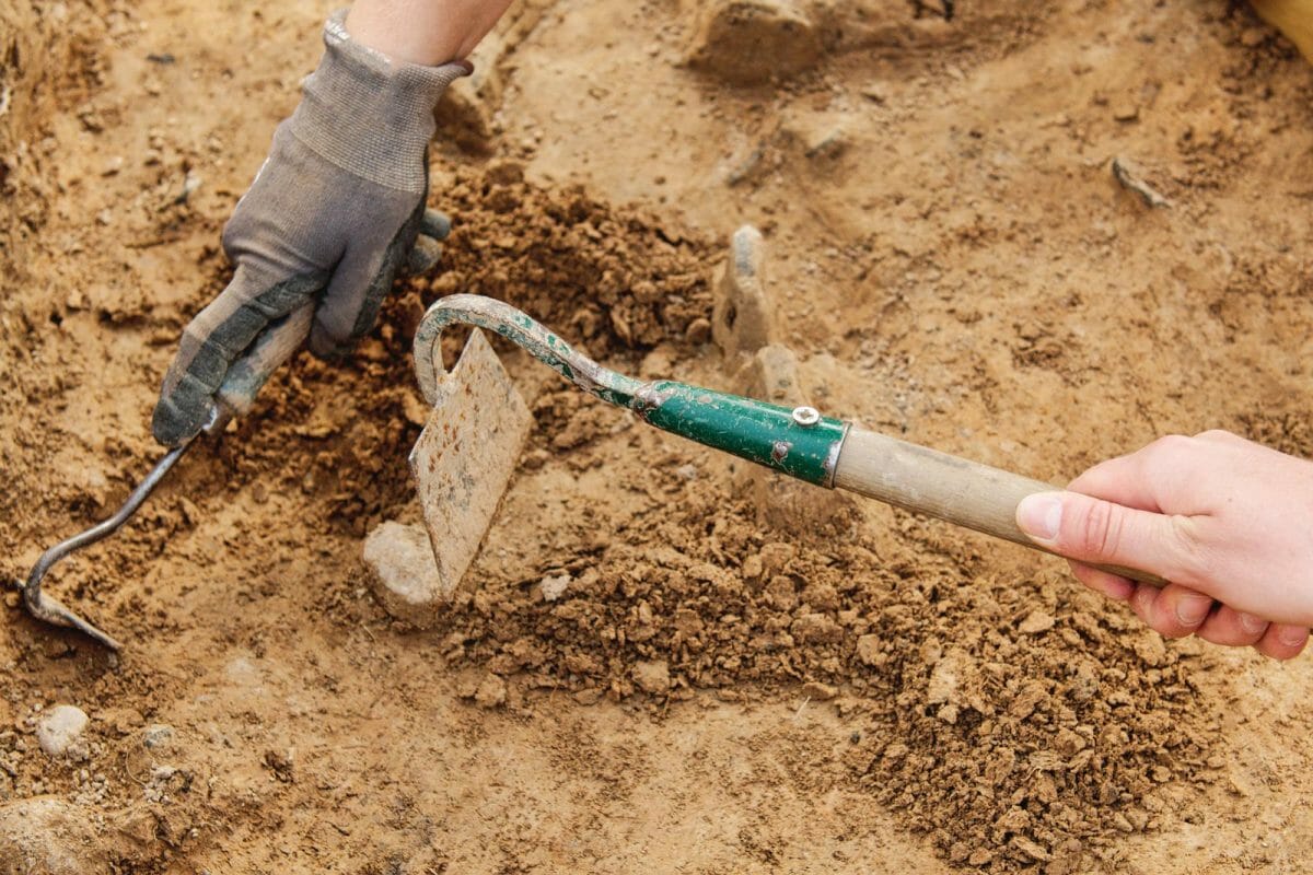 archaeologist digging tools site